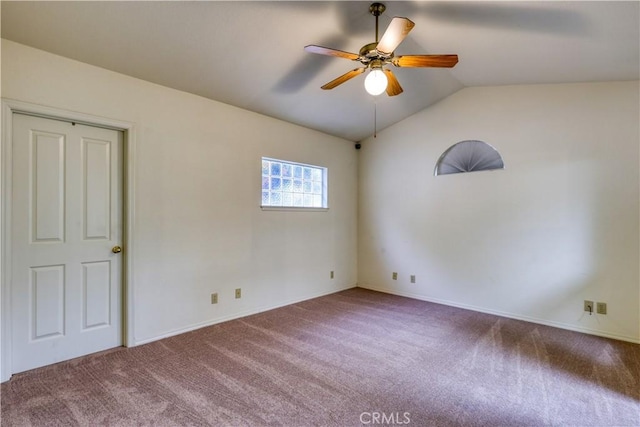 spare room with lofted ceiling, carpet flooring, and ceiling fan