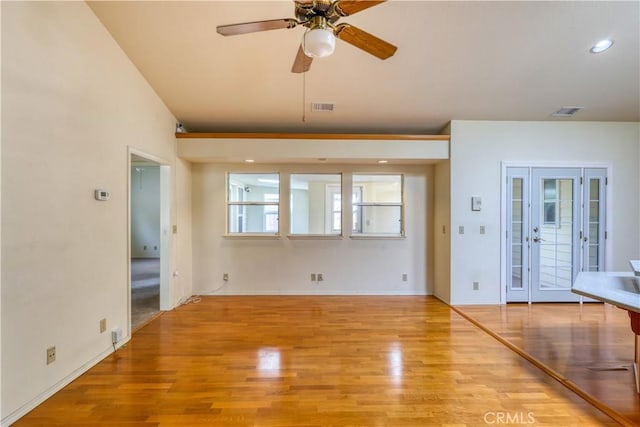 unfurnished living room featuring ceiling fan and light hardwood / wood-style flooring