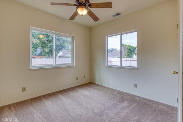 carpeted spare room with ceiling fan