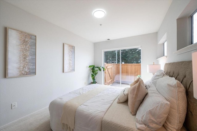 carpeted bedroom featuring access to outside