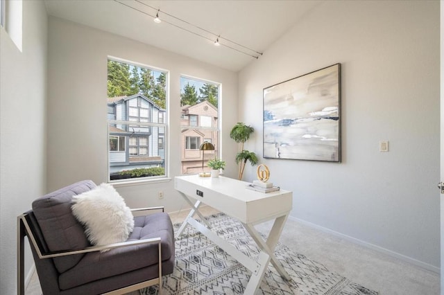 carpeted office featuring vaulted ceiling