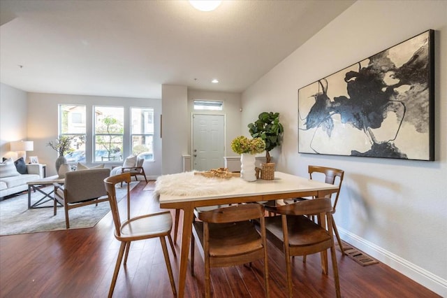 dining space with wood-type flooring