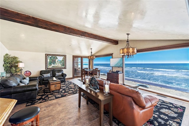 living room featuring a chandelier, lofted ceiling with beams, and hardwood / wood-style floors