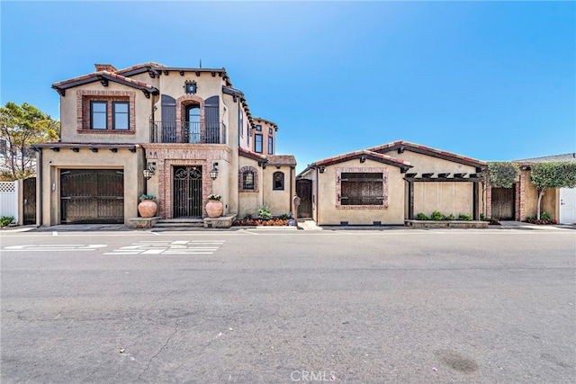 mediterranean / spanish-style house with a garage