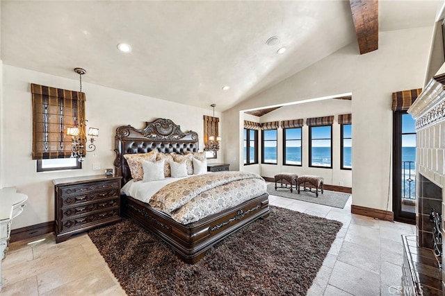 bedroom featuring lofted ceiling with beams, a water view, and a chandelier