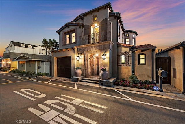 view of front of house with a balcony and a garage