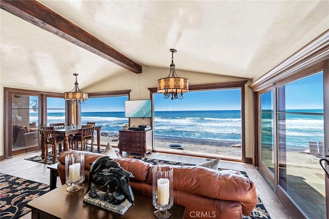 living room featuring lofted ceiling with beams, hardwood / wood-style floors, and a chandelier