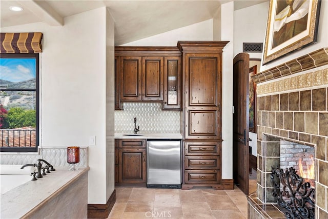 kitchen featuring lofted ceiling with beams, sink, refrigerator, and decorative backsplash