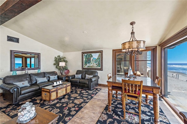 living room with lofted ceiling, a notable chandelier, and a water view