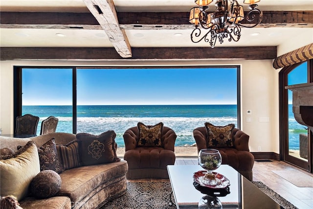 living room featuring hardwood / wood-style flooring, a chandelier, beamed ceiling, and a water view