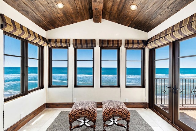 sunroom featuring a water view, vaulted ceiling with beams, and wooden ceiling