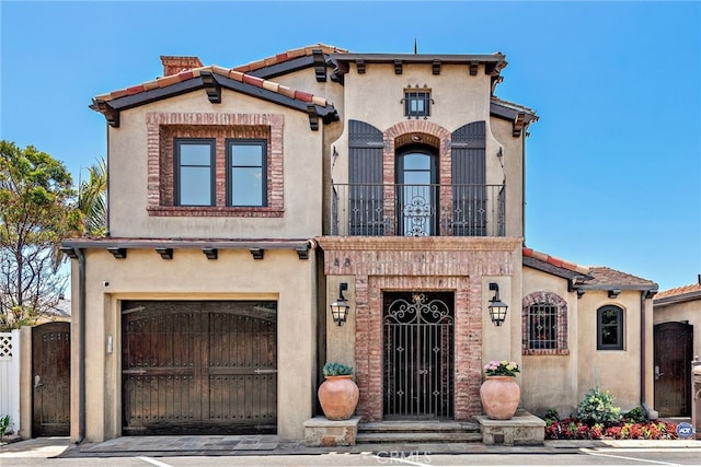 mediterranean / spanish home with a garage