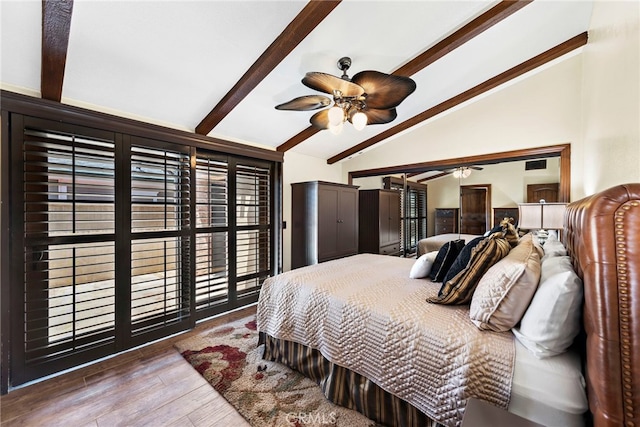 bedroom with lofted ceiling with beams and wood-type flooring