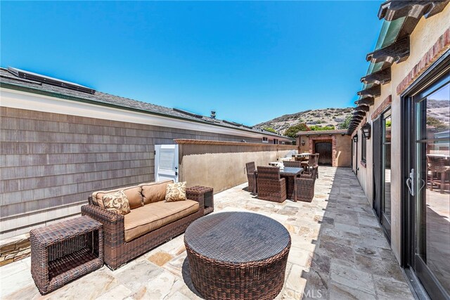 view of patio / terrace with a mountain view and an outdoor living space