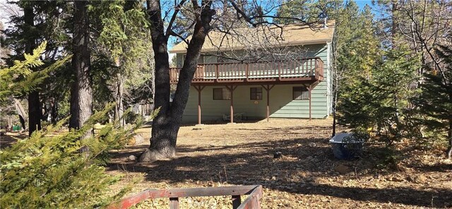 back of house with a wooden deck