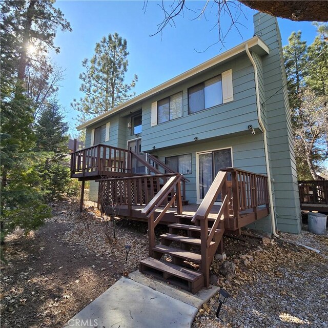 back of house with a wooden deck