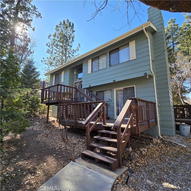 back of property featuring a wooden deck