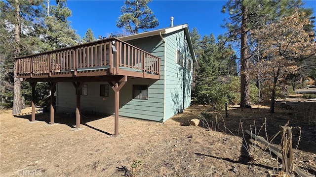 rear view of property with a wooden deck