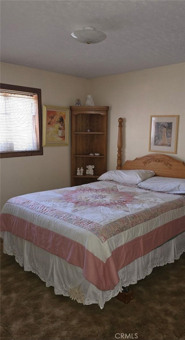 carpeted bedroom with a textured ceiling
