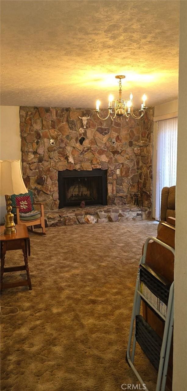 carpeted living room featuring a stone fireplace, a textured ceiling, and a chandelier