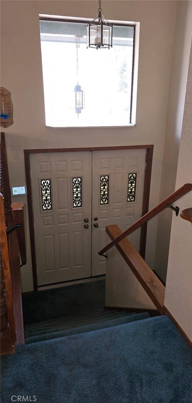 foyer entrance with a chandelier