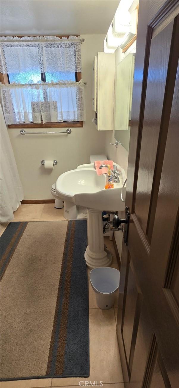 bathroom with tile patterned floors and toilet