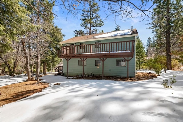 rear view of property featuring a deck