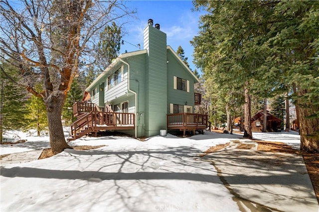 exterior space with a chimney and a wooden deck