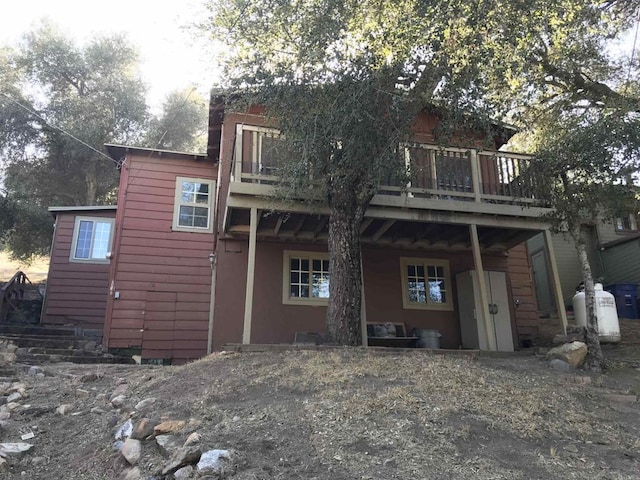 rear view of house featuring a balcony