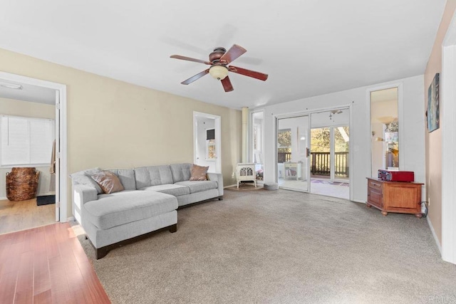 living room with hardwood / wood-style flooring and ceiling fan