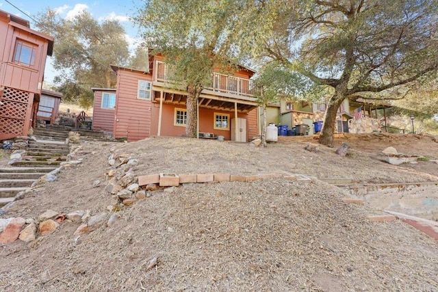 back of house with a wooden deck