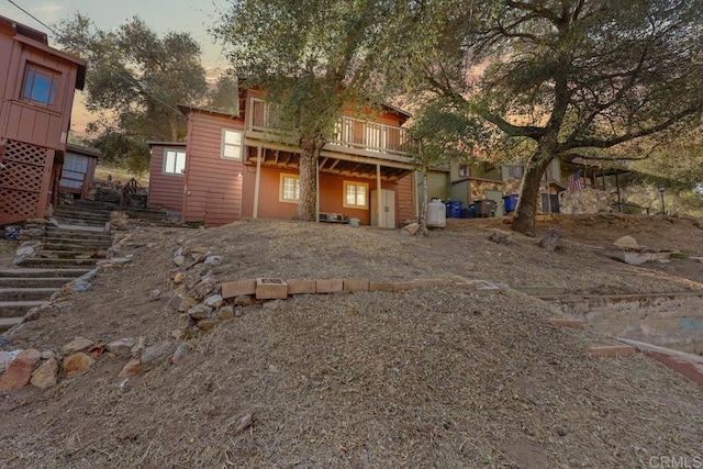 back house at dusk with a deck