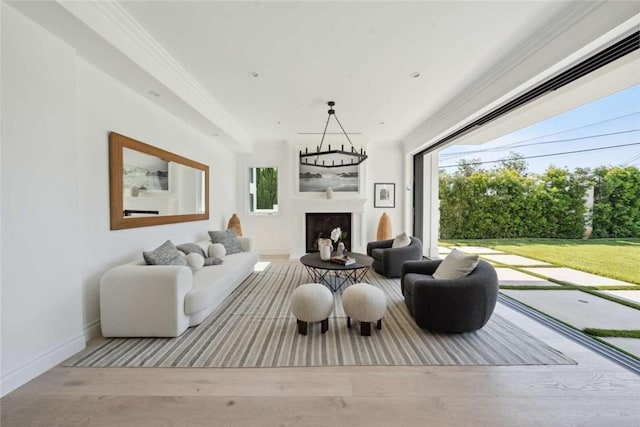 living room featuring crown molding and light wood-type flooring