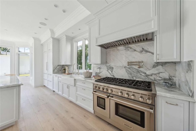 kitchen with sink, crown molding, light wood-type flooring, double oven range, and white cabinets