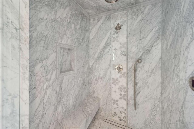 interior details featuring tiled shower