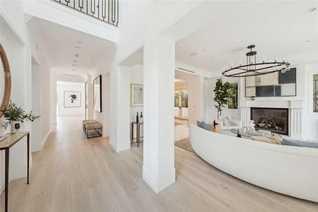 living room with a chandelier and light hardwood / wood-style floors