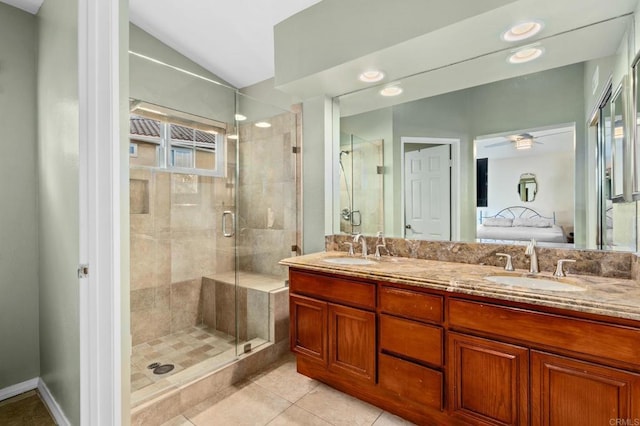 bathroom featuring vaulted ceiling, vanity, ceiling fan, a shower with door, and tile patterned floors