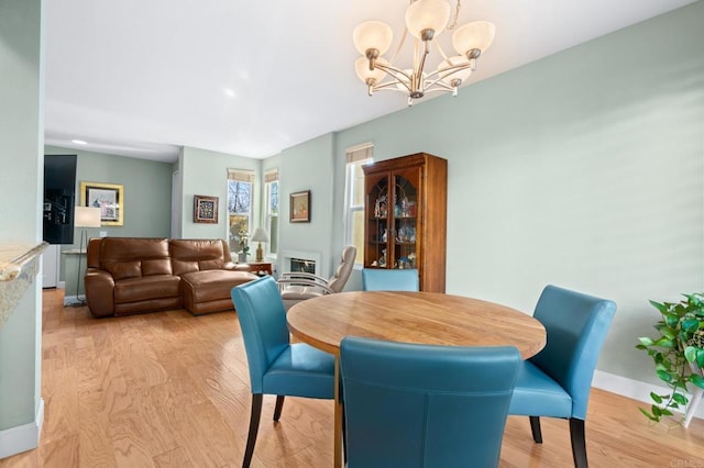 dining room with a chandelier and light wood-type flooring