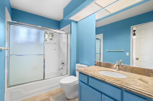 full bathroom with vanity, bath / shower combo with glass door, and toilet