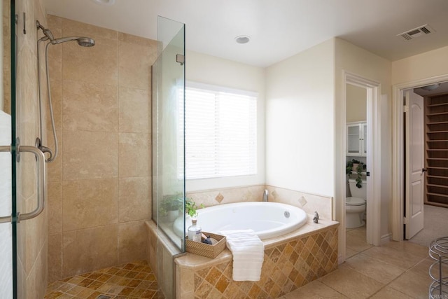 bathroom featuring shower with separate bathtub, tile patterned floors, and toilet