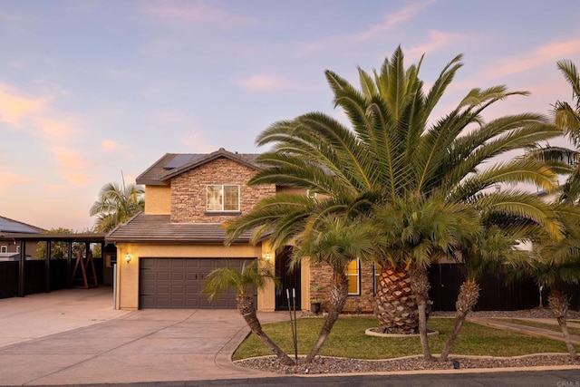 view of front facade with a yard, a garage, and a carport