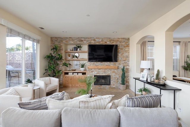 living room with built in features and a fireplace