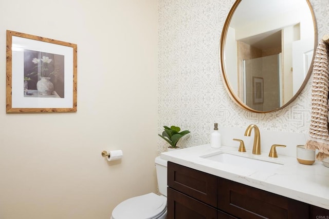 bathroom featuring vanity, toilet, and a shower