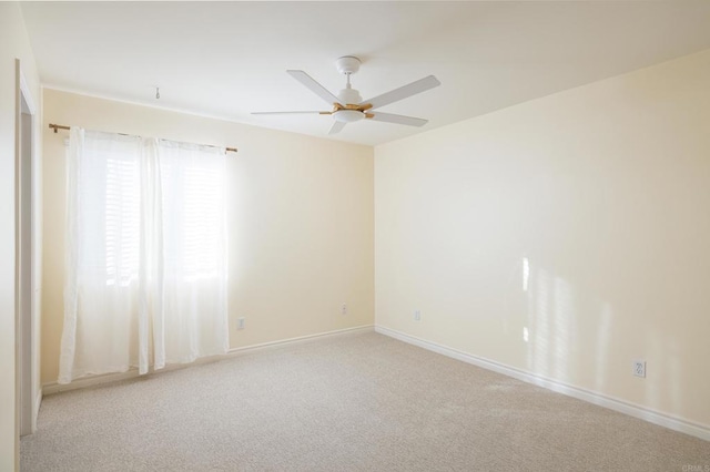 carpeted spare room with ceiling fan