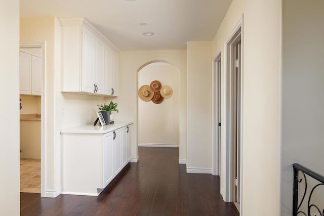 corridor with dark hardwood / wood-style flooring