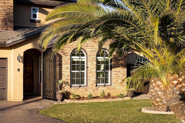 entrance to property with a lawn