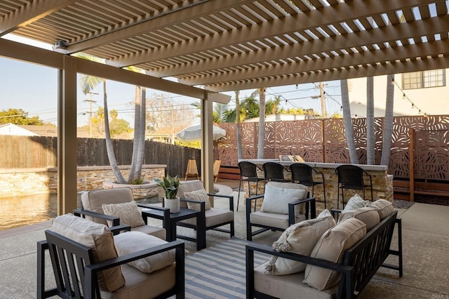 view of patio / terrace with an outdoor living space, exterior bar, and a pergola