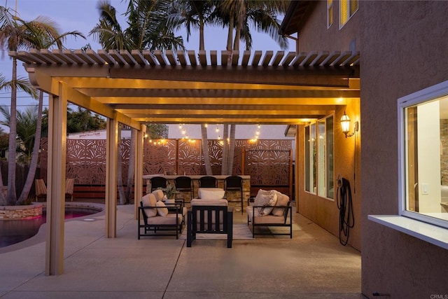 patio terrace at dusk with an outdoor living space and a pergola