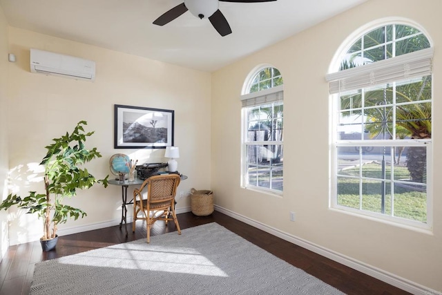 office area with dark wood-type flooring, ceiling fan, and a wall mounted AC