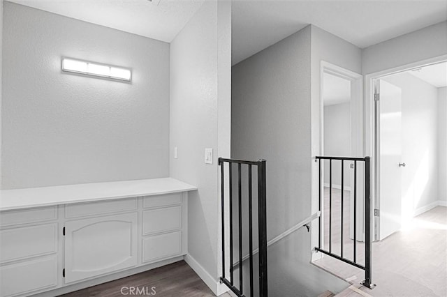 hallway with hardwood / wood-style floors